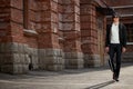 Blind man walking alone in city