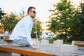 Blind man with a walking stick sitting on a bench at a park Royalty Free Stock Photo