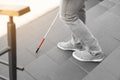 Blind person with cane going down stairs outdoors Royalty Free Stock Photo