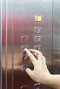 Blind person finger reading braille on elevator lift panel