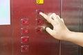 Blind person finger reading braille on elevator lift panel