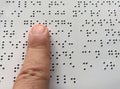Blind person reads braille alphabet text Royalty Free Stock Photo