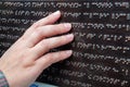 A blind person reads braille, female hand