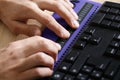 Blind person using computer with braille computer display