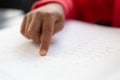 Blind schoolboy hand reading a braille book in classroom Royalty Free Stock Photo