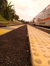 blind track in yellow with a train in the background