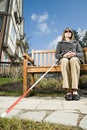 Blind woman sitting on a bench