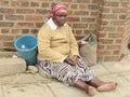 Blind woman sitting in a pavement
