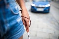 Blind woman walking on city streets, using her white cane