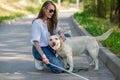 Blind young woman cuddling with guide dog on a walk outdoors. Royalty Free Stock Photo