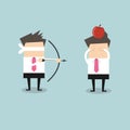 Blindfold businessman aiming to shoot at apple on another man's head Royalty Free Stock Photo