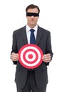 Blindfolded businessman holding a red target Royalty Free Stock Photo