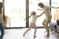 Blindfolded girl catching father playing hide and seek with fami Royalty Free Stock Photo