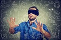 Blindfolded young business man searching walking through social media financial data plan Royalty Free Stock Photo