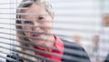 Through the blinds. successful businesswoman looking through office window Royalty Free Stock Photo