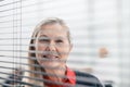 Through the blinds. successful businesswoman looking through office window Royalty Free Stock Photo