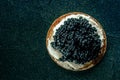 A blini with caviar and cream cheese, overhead flat lay shot