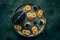 Blinis with black caviar and cream cheese, overhead flat lay shot on black