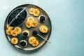 Blinis with black caviar and cream cheese, overhead flat lay shot