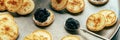 Blinis with black caviar and cream cheese panorama, on a festive dish