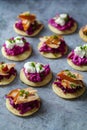 Blinis with creamy beetroot, goat cheese and hot smoked salmon