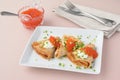 Blinis with red caviar and sour cream decorated with green onion