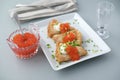 Blinis with red caviar and sour cream decorated with green onion