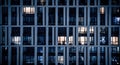 Blinking and flashing windows of the multi-storey building of glass and steel lighting inside. Aerial view of modern Royalty Free Stock Photo