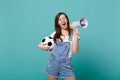 Blinking girl football fan scream in megaphone support favorite team with soccer ball isolated on blue turquoise Royalty Free Stock Photo