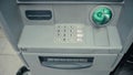 Blinking green slot in gray ATM cash machine. ATM machine