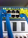 Blinking network ethernet active switch with connected cables in server room Royalty Free Stock Photo