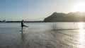 Bliss Teenager splashing while kick the water with the leg, having fun in the sea walking in the sunset. Lady laugh and splash Royalty Free Stock Photo