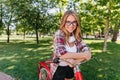 Blissful cute lady with bicycle looking to camera with smile. Outdoor shot of gorgeous white girl e Royalty Free Stock Photo