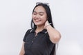 A blissful Filipino woman with straight long hair in her early 20s. Wearing a black polo shirt. Isolated on a white background Royalty Free Stock Photo