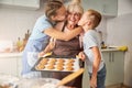 Blissful grandma being kissed by thankful children