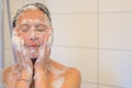 Blissful middle-aged woman enjoying a shower