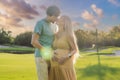 A blissful moment as a pregnant woman and her husband spend quality time together outdoors, savoring each other& x27;s Royalty Free Stock Photo