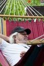 Blissful relaxation for the old man in the hammock. Serene old man enjoying a hammock. Contented old man finding solace in a Royalty Free Stock Photo