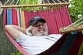 Blissful relaxation for the old man in the hammock. Serene old man enjoying a hammock. Contented old man finding solace in a Royalty Free Stock Photo