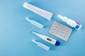 Blister pack of blue pills, ampoules, nasal spary, white ointment and digital thermometer Royalty Free Stock Photo