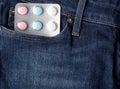 Blister pack of colorful pills in jeans pocket Royalty Free Stock Photo