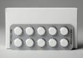 White round pills in blister pack with plain white box background Royalty Free Stock Photo