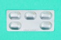 Blister or pack of five tablets or pills. The concept of five working days. Turquoise classic medical background