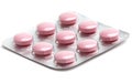 A blister pack containing ten pink tablets on a white background, symbolizing health and medication Royalty Free Stock Photo