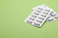 Blisters with chewing gums on pale green background. Space for text Royalty Free Stock Photo