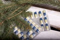The blisters with pills. Different colors. Spruce branches. On a wooden box Royalty Free Stock Photo