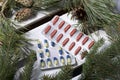 The blisters with pills. Different colors. Spruce and pine branches with cones. On a wooden box Royalty Free Stock Photo