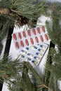 The blisters with pills. Different colors. Spruce and pine branches with cones. On a wooden box Royalty Free Stock Photo