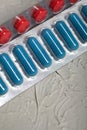 Blisters with red and blue tablets. On a light background. Close-up Royalty Free Stock Photo