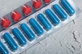 Blisters with red and blue tablets. On a light background. Close-up Royalty Free Stock Photo